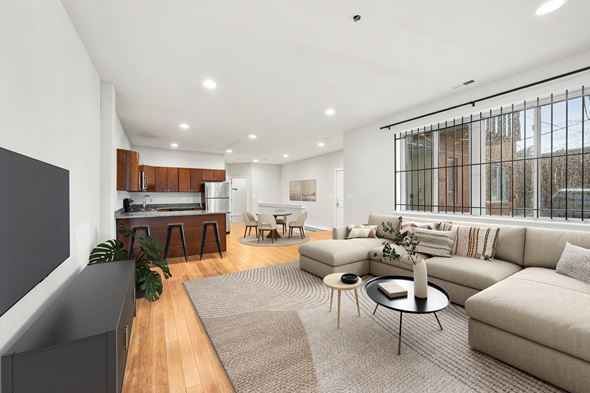 Philadelphia apartment for rent - A modern living room with a grey carpet and a large window.