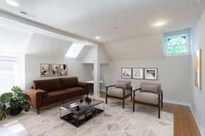 Philadelphia apartment for rent - A living room with a brown couch, two chairs, and a coffee table.