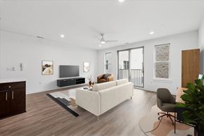 Philadelphia apartment for rent - A living room with a white couch, a television, and a ceiling fan.