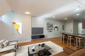 Philadelphia apartment for rent - A living room with a couch, a coffee table, and a television.