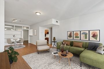 Philadelphia apartment for rent - A living room with a green couch, a coffee table, and a painting on the wall.