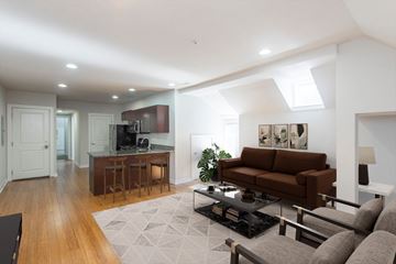 Philadelphia apartment for rent - A modern living room with a brown couch and a black coffee table.