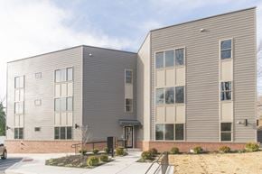 Philadelphia apartment for rent - the front of a gray building with a sidewalk in front of it