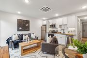 Philadelphia apartment for rent - A modern living room with a grey couch and a wooden coffee table.