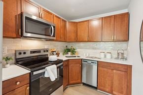Philadelphia apartment for rent - A kitchen with wooden cabinets and a black oven.