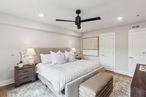 Philadelphia apartment for rent - A bedroom with a large bed, a ceiling fan, and a rug on the floor.