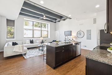 Philadelphia apartment for rent - A modern kitchen with dark wood cabinets and a granite countertop.