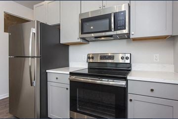 Philadelphia apartment for rent - a kitchen with stainless steel appliances and white cabinets