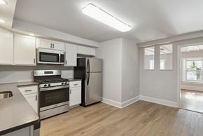 Philadelphia apartment for rent - a kitchen with white cabinets and stainless steel appliances