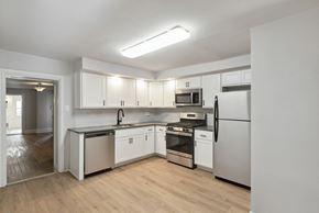 Philadelphia apartment for rent - a kitchen with white cabinets and stainless steel appliances