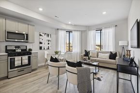 Philadelphia apartment for rent - a living room and kitchen area with white walls and a wooden floor