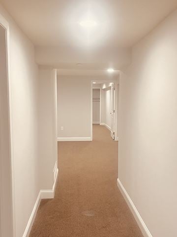 Philadelphia apartment for rent - a spacious living room and hallway with white walls and carpet