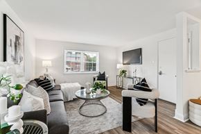 Flourtown apartment for rent - A living room with a grey couch, a coffee table, and a television.
