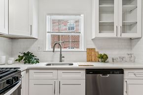 Flourtown apartment for rent - A modern kitchen with white cabinets and a stainless steel dishwasher.