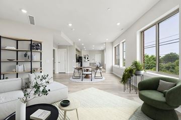 Philadelphia apartment for rent - A living room with a white sofa, a green armchair, and a coffee table.