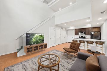 Philadelphia apartment for rent - A living room with a television and a staircase.
