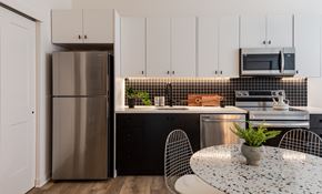 Philadelphia apartment for rent - a kitchen with white cabinets and stainless steel appliances