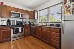 Philadelphia apartment for rent - a kitchen with wooden cabinets and stainless steel appliances