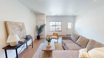 Fargo townhouse for rent - A living room with a brown couch and a painting on the wall.