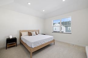 Fargo townhouse for rent - A bedroom with a bed, nightstand, and window.
