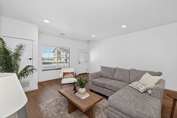 Fargo townhouse for rent - A living room with a grey couch and a wooden coffee table.
