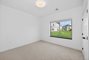Fargo townhouse for rent - A room with a window showing a view of houses and trees.