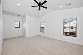 Fargo townhouse for rent - A spacious room with a ceiling fan and two windows.