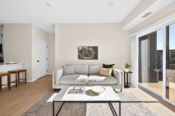 Fargo apartment for rent - A living room with a couch, a coffee table, and a painting on the wall.