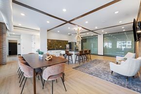 Fargo apartment for rent - A modern dining room with a wooden table and chairs.
