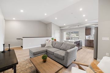Fargo townhouse for rent - A living room with a grey couch and a wooden coffee table.