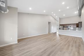 Fargo townhouse for rent - A spacious room with wooden flooring and white walls.