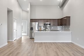 Fargo townhouse for rent - A kitchen with a white counter and wooden floors.