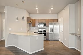 Fargo apartment for rent - A kitchen with a white counter top and stainless steel appliances.
