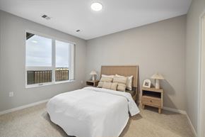 Fargo apartment for rent - a white bedroom with a large window and a bed