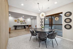 Fargo apartment for rent - a dining area with a round table and chairs and a glass sliding door