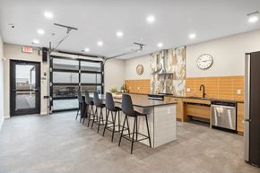 Fargo apartment for rent - a kitchen with an island and chairs in front of a door