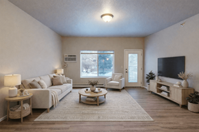 Fargo apartment for rent - A living room with a couch, a chair, a coffee table, and a television.
