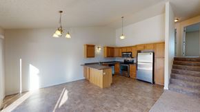 West Fargo townhouse for rent - A kitchen with a refrigerator, oven, and microwave.