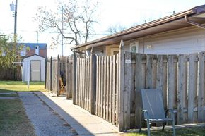 West Fargo triplex for rent - A wooden fence with a bench in front of it.