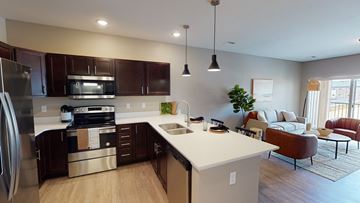 Fargo apartment for rent - an open kitchen and living room with a couch and a table