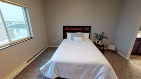 Moorhead apartment for rent - A bedroom with a large bed and a window.