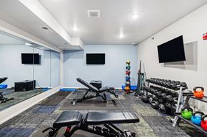 Bismarck apartment for rent - A gym with a variety of equipment including weights and exercise machines.