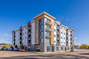 Bismarck apartment for rent - A large apartment building with a parking lot in front.
