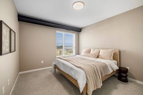 Fargo apartment for rent - A bedroom with a large bed and a window overlooking the ocean.