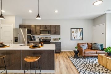 Fargo apartment for rent - a living room with a kitchen and a couch