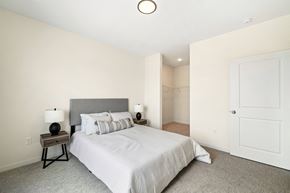 West Fargo apartment for rent - a bedroom with a large bed and a closet at The Standard on 32nd, West Fargo