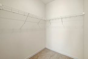 West Fargo apartment for rent - a spacious closet with white walls and shelves and a carpeted floor at The Standard on 32nd, West Fargo, North Dakota