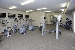Watford City apartment for rent - a gym with various exercise equipment in a building