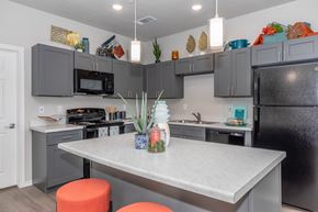 Waco apartment for rent - A kitchen with a table and chairs in the foreground.