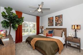 Temple apartment for rent - A bedroom with two beds and a ceiling fan.
